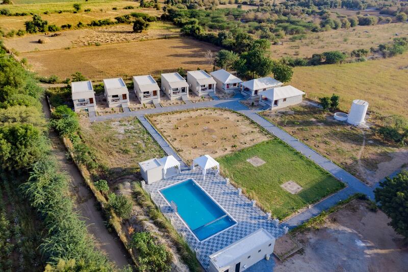 The resort from above: cottages, tents, lawn and pool