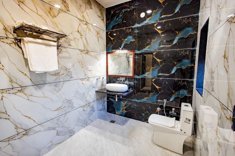 A marble bathroom with a rain shower