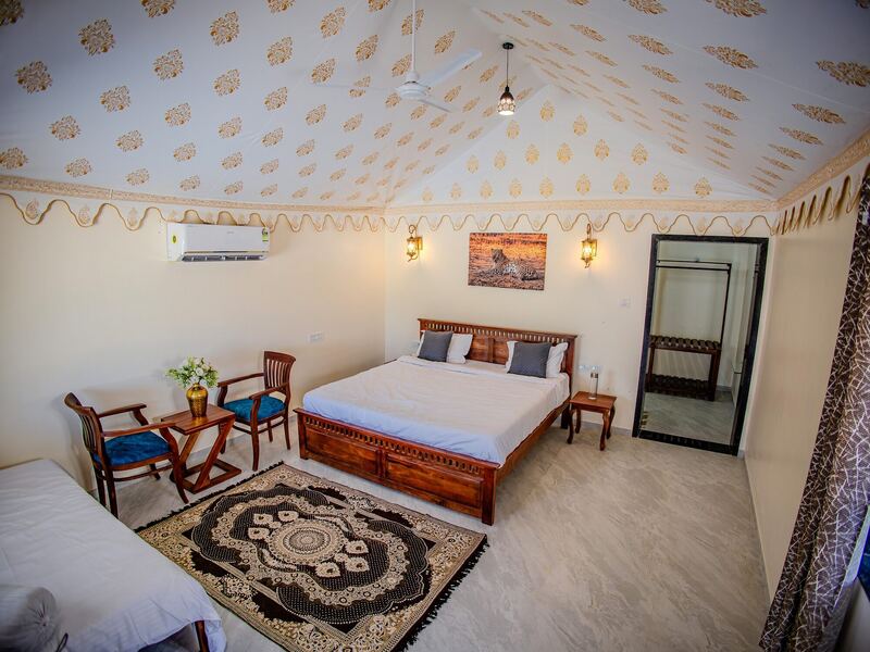 Inside a tent: block-printed canvas ceiling and a double bed